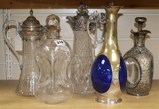 A dimple decanter with silver mount, two claret jugs with plated mounts and two other items